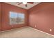 Bedroom featuring a ceiling fan, carpeted floor, and natural light from a window at 18434 E El Buho Pequeno Rd, Gold Canyon, AZ 85118