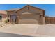 Charming single-story home featuring desert landscaping, a two-car garage and neutral exterior paint at 18434 E El Buho Pequeno Rd, Gold Canyon, AZ 85118