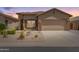 Charming single-story home featuring desert landscaping, a two-car garage and neutral exterior paint at 18434 E El Buho Pequeno Rd, Gold Canyon, AZ 85118