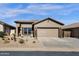 Charming single-story home featuring desert landscaping, a two-car garage and neutral exterior paint at 18434 E El Buho Pequeno Rd, Gold Canyon, AZ 85118