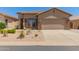 Charming single-story home featuring desert landscaping, a two-car garage and neutral exterior paint at 18434 E El Buho Pequeno Rd, Gold Canyon, AZ 85118