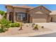 Charming single-story home featuring desert landscaping, a two-car garage and neutral exterior paint at 18434 E El Buho Pequeno Rd, Gold Canyon, AZ 85118