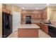 Well-lit kitchen showcasing ample counter space, a center island, and modern appliances for efficient meal preparation at 18434 E El Buho Pequeno Rd, Gold Canyon, AZ 85118