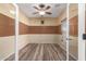 This office features wood-look tile floors, neutral paint, a ceiling fan and large windows at 18434 E El Buho Pequeno Rd, Gold Canyon, AZ 85118