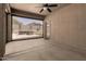 Enclosed patio with screens offering seamless indoor/outdoor living with door to the yard at 18434 E El Buho Pequeno Rd, Gold Canyon, AZ 85118
