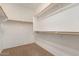 Walk-in closet with carpet and built-in shelving and wooden clothing rods at 18434 E El Buho Pequeno Rd, Gold Canyon, AZ 85118