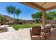 Inviting backyard oasis featuring a decorative water feature and manicured landscaping at 18547 W Sweet Acacia Dr, Goodyear, AZ 85338