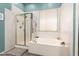 Bright bathroom showcasing a shower, a soaking tub, and mosaic tile details at 18547 W Sweet Acacia Dr, Goodyear, AZ 85338
