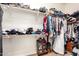 Walk-in closet with shelving and hanging rods for optimal organization and storage solutions at 18547 W Sweet Acacia Dr, Goodyear, AZ 85338