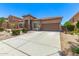 Charming single-Gathering home with a spacious driveway and well-maintained desert landscaping at 18547 W Sweet Acacia Dr, Goodyear, AZ 85338