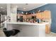 Spacious kitchen with a breakfast bar, stainless steel appliances, and bright wood cabinets for a cozy feel at 18547 W Sweet Acacia Dr, Goodyear, AZ 85338