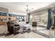 Open-concept living room with modern decor, tile flooring, and an inviting atmosphere at 18547 W Sweet Acacia Dr, Goodyear, AZ 85338