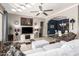 Spacious living room with tile floors, comfortable furniture, and seamless access to the dining area at 18547 W Sweet Acacia Dr, Goodyear, AZ 85338