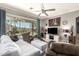 Comfortable living room with tile floors, plush furniture, and views of the backyard at 18547 W Sweet Acacia Dr, Goodyear, AZ 85338