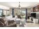 Bright living room with tile floors, plush furniture, and backyard views at 18547 W Sweet Acacia Dr, Goodyear, AZ 85338