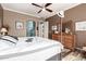 Comfortable bedroom featuring hardwood floors, an elegant dresser, and soft natural light at 18547 W Sweet Acacia Dr, Goodyear, AZ 85338
