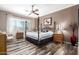 Relaxing main bedroom with a four-poster bed and a warm color palette and outdoor view at 18547 W Sweet Acacia Dr, Goodyear, AZ 85338