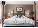 Cozy bedroom featuring a four-poster bed, decorative pillows, and complementing lamps at 18547 W Sweet Acacia Dr, Goodyear, AZ 85338