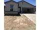 Charming single-Gathering home featuring a spacious two-car garage and low maintenance desert landscaping at 1947 E Bucking Bronco Dr, San Tan Valley, AZ 85140
