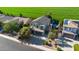 Aerial view of home highlighting lush greenbelt, three car garage, desert landscaping, and backyard pool at 1974 E Dubois Ave, Gilbert, AZ 85298