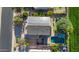 Drone shot of home featuring solar panels, pool, putting green and backyard entertaining space at 1974 E Dubois Ave, Gilbert, AZ 85298