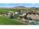 View of neighborhood, backyard putting green, pool and distant mountain views at 1974 E Dubois Ave, Gilbert, AZ 85298