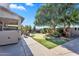 Beautiful backyard with lush landscaping, mature trees, putting green and covered patio area for entertaining at 1974 E Dubois Ave, Gilbert, AZ 85298