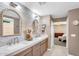 Bathroom with double sinks, decorative mirrors, and access to the bedroom, offering a serene and functional space at 1974 E Dubois Ave, Gilbert, AZ 85298