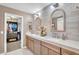 Elegant bathroom features double sinks, white countertops, stylish fixtures, and an entrance to a walk-in closet at 1974 E Dubois Ave, Gilbert, AZ 85298