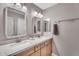 Elegant bathroom with double sinks, framed mirrors, light wood cabinetry, and modern fixtures at 1974 E Dubois Ave, Gilbert, AZ 85298