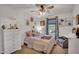 This cozy bedroom showcases decorative touches, including posters, a ceiling fan, and soft, inviting textiles at 1974 E Dubois Ave, Gilbert, AZ 85298