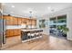 Bright kitchen with wood cabinetry, large island with seating, and sliding doors to the patio at 1974 E Dubois Ave, Gilbert, AZ 85298