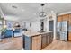 Modern kitchen with granite countertops, stainless steel appliances, and seamless flow to the living area at 1974 E Dubois Ave, Gilbert, AZ 85298
