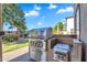 Outdoor kitchen featuring stainless steel grill, prep area, and convenient access to backyard amenities at 1974 E Dubois Ave, Gilbert, AZ 85298