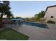 Evening view of a backyard pool with vibrant lighting, creating a magical and inviting outdoor oasis at 1974 E Dubois Ave, Gilbert, AZ 85298