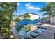 Backyard pool with built in seating, featuring an umbrella, providing a relaxing and luxurious outdoor space at 1974 E Dubois Ave, Gilbert, AZ 85298