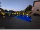Nighttime view of a sparkling pool, highlighting the ambient lighting and serene backyard atmosphere at 1974 E Dubois Ave, Gilbert, AZ 85298