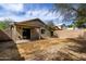 Exterior shot of backyard featuring covered patio, block wall, and lush trees with desert landscaping at 2153 E Crest Ln, Phoenix, AZ 85024