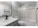 Bathroom with vanity, mirror, and a shower-tub combination with glass doors at 2153 E Crest Ln, Phoenix, AZ 85024