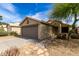 Charming single-story home with a two car garage, landscaped front yard, and light beige stucco exterior at 2153 E Crest Ln, Phoenix, AZ 85024