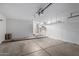 Spacious two car garage with clean epoxy flooring, water heater, and overhead garage door opener at 2153 E Crest Ln, Phoenix, AZ 85024