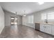 Kitchen area featuring tile floors, white cabinets, and a stainless steel sink at 2153 E Crest Ln, Phoenix, AZ 85024