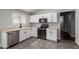 Bright kitchen featuring white cabinets, stainless steel appliances, tile flooring, and a large stainless steel sink at 2153 E Crest Ln, Phoenix, AZ 85024