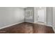 Light and airy living room with dark wood flooring, white trim, neutral paint, and a view of the front entryway at 2153 E Crest Ln, Phoenix, AZ 85024