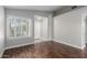 Light and airy living room with dark wood flooring, white trim, neutral paint, and a view of the front entryway at 2153 E Crest Ln, Phoenix, AZ 85024