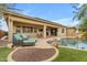 Inviting backyard oasis with a covered patio, sparkling pool, lounge chairs, and lush landscaping at 22639 E Avenida Del Valle --, Queen Creek, AZ 85142