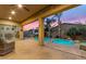 Covered patio opens to a refreshing pool area with rock accents and tropical landscaping at 22639 E Avenida Del Valle --, Queen Creek, AZ 85142