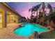Sparkling backyard pool surrounded by lush greenery, palm trees, and rock features at 22639 E Avenida Del Valle --, Queen Creek, AZ 85142