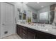 Bathroom with double sinks, dark cabinets, large mirrors, and decorative elements for a spa-like ambiance at 22639 E Avenida Del Valle --, Queen Creek, AZ 85142