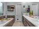Luxurious bathroom featuring a soaking tub, a dual sink vanity, and elegant decor, creating a serene retreat at 22639 E Avenida Del Valle --, Queen Creek, AZ 85142